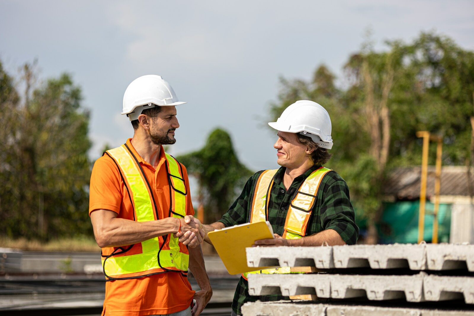 Construction workers shake hands after a deal.